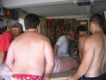 Ed, Brad, Ed jr, Mike and Tim carry him to the garage